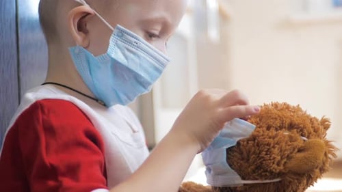 Boy with Medical Mask on Teddy Bear
