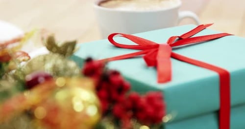 Close-up of coffee cup with christmas decoration and gift 4k