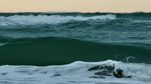 Rolling Ocean Waves Under Sunset