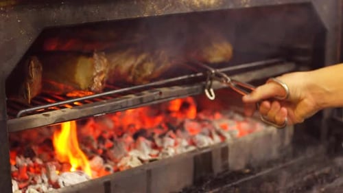 Cooking Delicious Juicy Meat Steaks on the Grill on Fire.