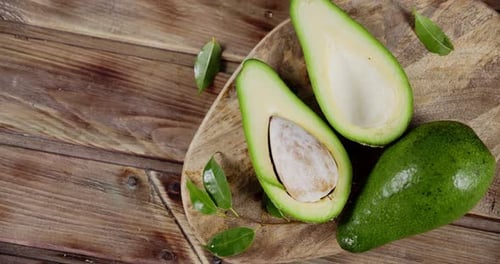 Rotating Fresh Avocado on a Cutting Board.