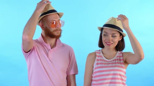Couple Puts on Hats and Laughs Together