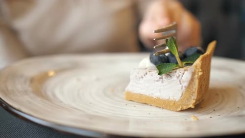 Female Hands Eating Cheese Cake in the Cafe