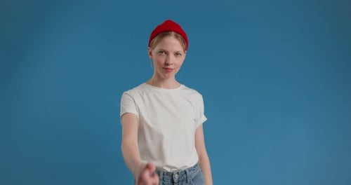 Playful Young Adult Gesticulating on Blue Backdrop