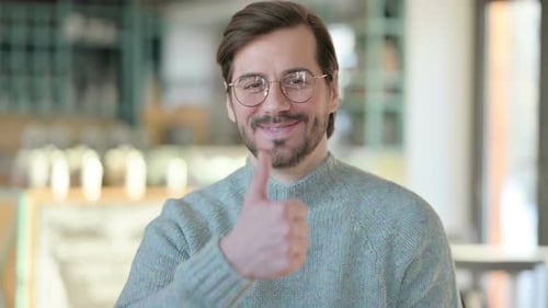 Man Giving Thumbs Up and Smiling