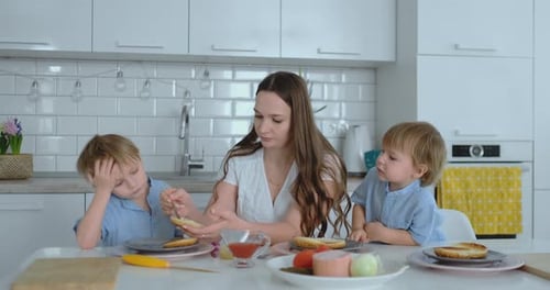 Woman Makes Open-faced Sandwiches with Her Children