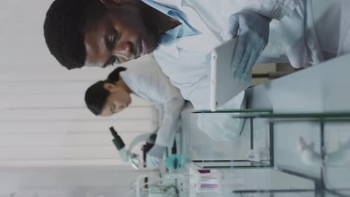 Scientists Studying Data and Analyzing Research in Laboratory