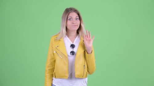Mujer rubia rebelde joven feliz con signo de aprobación
