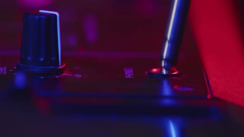 Closeup of Plug Headphones Inserted Into Digital Mixing Music Station