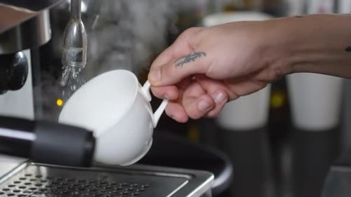 Close Up of Hot Water Pouring Into White Mug