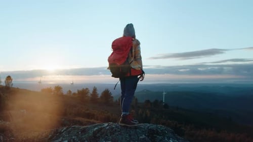 Woman Hiker on Adventure Trip in Mountain Sunset