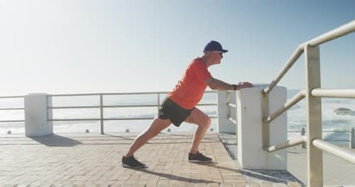 Senior man performing stretching exercise on the promenade