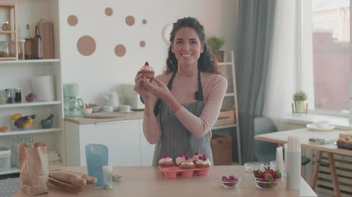 Woman Holding and Describing Cupcake
