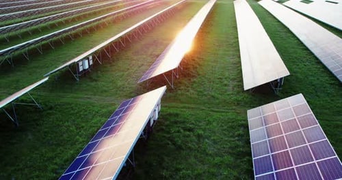 Back Side of the Solar Panels of a Modern Power Plant in the Evening at Sunset