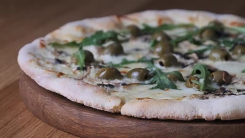 Appetizing Pizza on a Wooden Table in a Restaurant