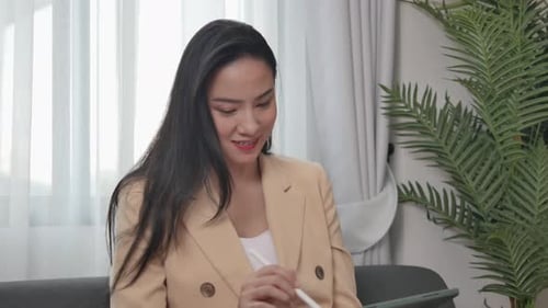 Woman uses on tablet to draft content, present work project to client.