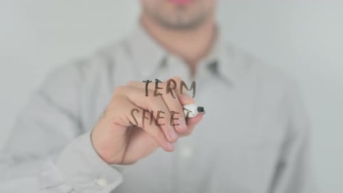 Man Writes Term Sheets on Clear Surface