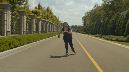 Smiling Woman Roller Skating on Paved Road