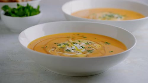 Soup in a Bowl Being Drizzled with Olive Oil