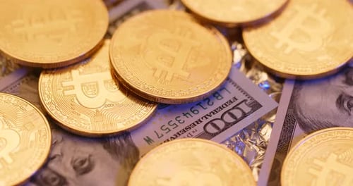 Bitcoin Coins and Hundred Dollar Bill Close Up
