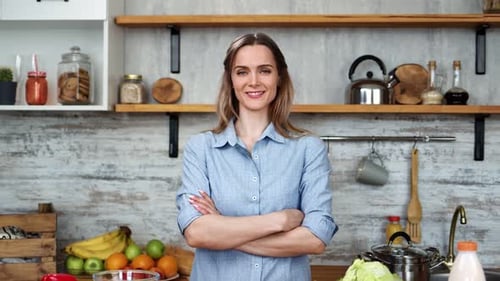 Smiling Woman with Fresh Food in a Kitchen