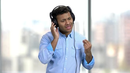 Man Listening to Music with Headphones and Singing