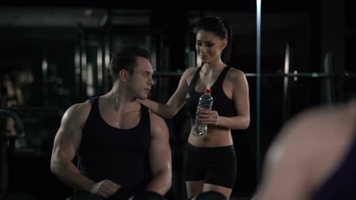 Athletic Man Exercising at Gym With Woman