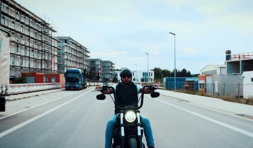 Motorcycle Driving on Empty Road in the City
