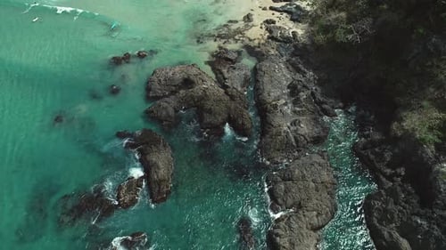 Aerial Top View of Sea Waves Crushing Into the Rocks Near Beach