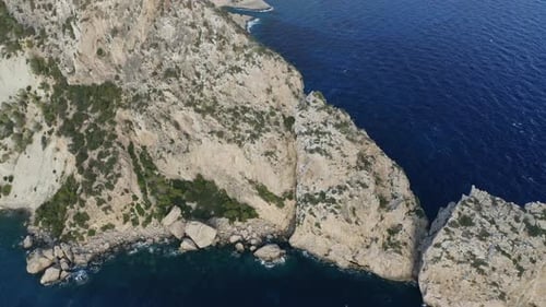Orbiting Around Cliff with Blue Ocean Waters Surrounding It