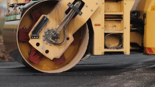 The Road Roller is Laying Asphalt