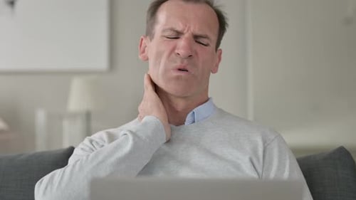 Man Massaging Neck in Discomfort