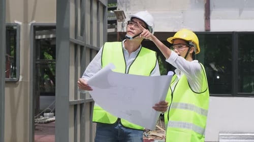 Engineers Discussing Plans on Construction Site