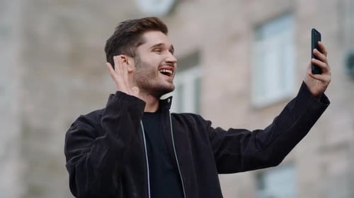 Smiling Man Looking Phone Screen Outdoors, Happy Guy Having Video Call on Street