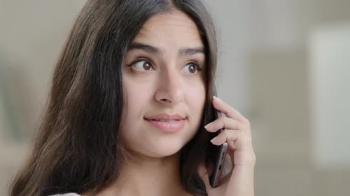 Concerned Young Woman Talking on Mobile Phone