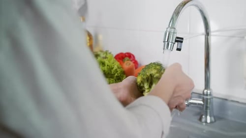 Close up of Woman Hand Washing a Fresh Vegetables