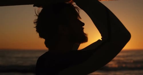 Man walking with surfboard in the beach 4k