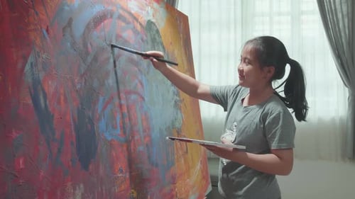 Young Artist Painting Abstract Art on Canvas