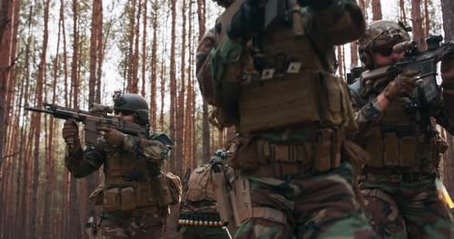 Four Fully Equipped Middle Aged Soldiers Wearing Camouflage Uniform Attacking Enemy They're in
