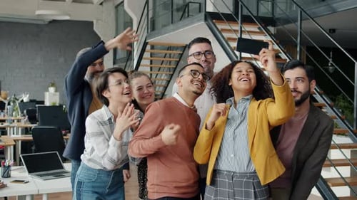 Enthusiastic Office Team Poses for Photo Together