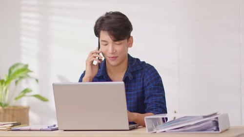 Young Adult Working and Talking on Phone