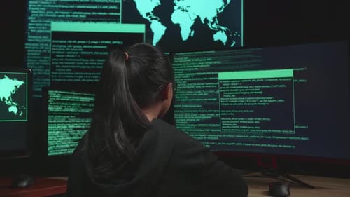 Asian Young Girl Hacker Hacking With Multiple Computer Screens In Dark Room