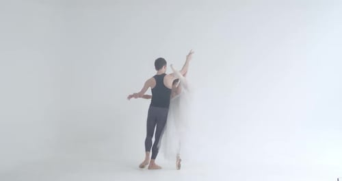 Ballet Dancers Gracefully Pose in a White Studio