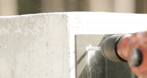 Close Up Of A Drill Bit Drilling Hole On Concrete Wall. slow motion