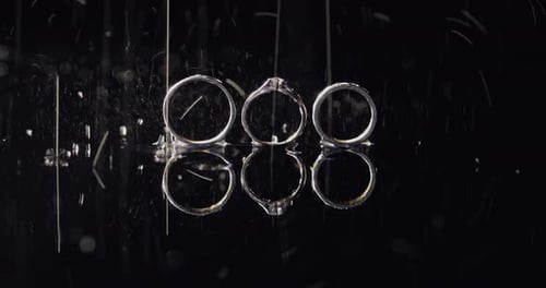 Wedding Rings Reflected with Rain and Sparkling Lights