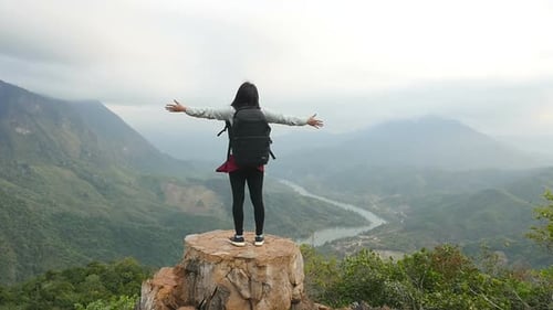 Woman Hiker Standing on Mountain Top with Backpack