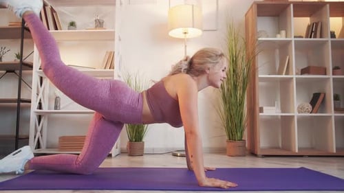 Woman Does Glute Exercise on Yoga Mat