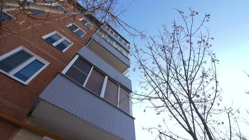 Old Apartment Building with Balconies and Red Facade