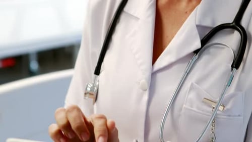 Medical Professional Uses Tablet in Hospital Setting