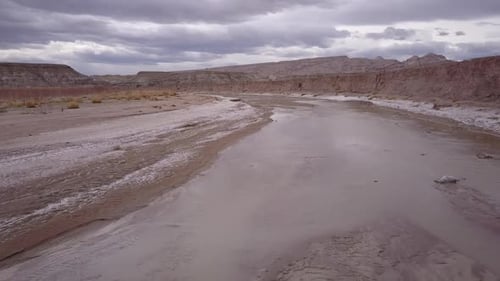 Slowly flying over shallow river in the desert